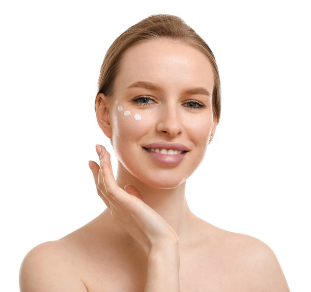 Beautiful woman with cream on her face against white background - Photo, Image