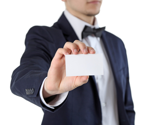 Homem elegante em terno segurando cartão de visita, isolado em branco
 - Foto, Imagem