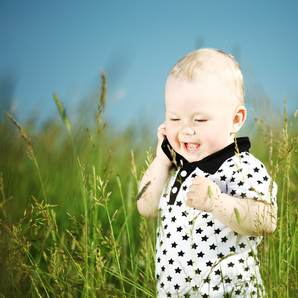 Boy in grass call by phone - Fotografie, Obrázek
