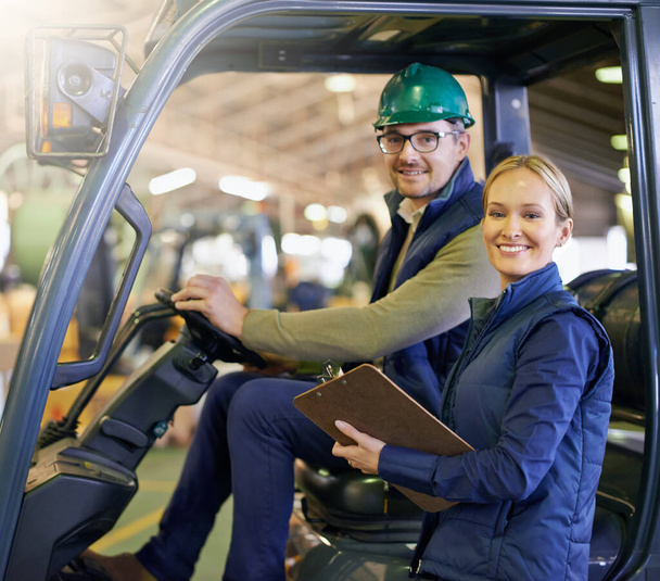 Portrait, warehouse and smile workers with forklift on site, loading on dock with Industrial moving vehicle. Teamwork, together or woman with clipboard for shipping inventory, hardhat for safety. - Photo, Image
