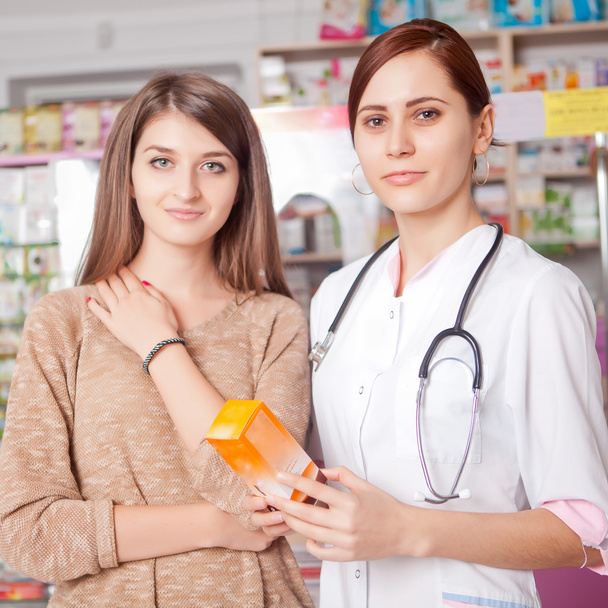 Woman doctor and client inside pharmacy - Foto, imagen