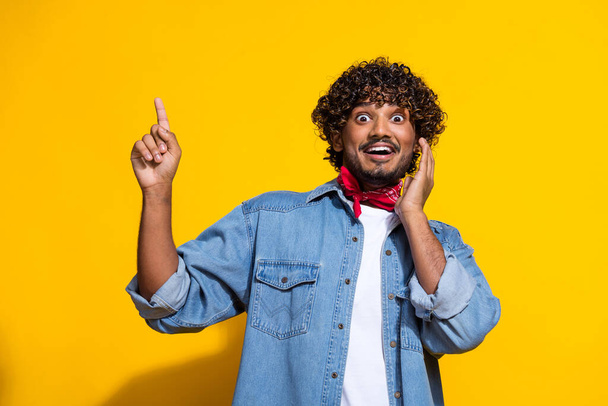 Photo portrait of nice young male point up excited empty space wear trendy denim outfit red scarf isolated on yellow color background. - Φωτογραφία, εικόνα