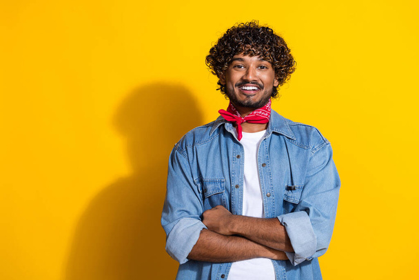Photo portrait of nice young male folded hands professional dressed stylish denim outfit red scarf isolated on yellow color background. - Zdjęcie, obraz