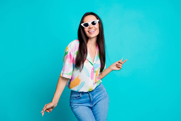 Photo of lovely cheerful funky woman wear stylish print clothes have fun night club isolated on cyan color background. - Foto, afbeelding