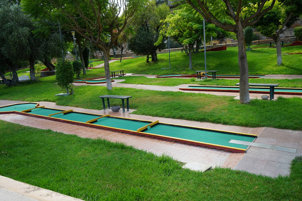 Miniature golf in Lardos. Miniature golf, minigolf, putt-putt, crazy golf, and by several other names is an offshoot of the sport of golf focusing solely on the putting aspect of its parent game. Lardos, Rhodes Island, South Aegean region, Greece - Photo, Image
