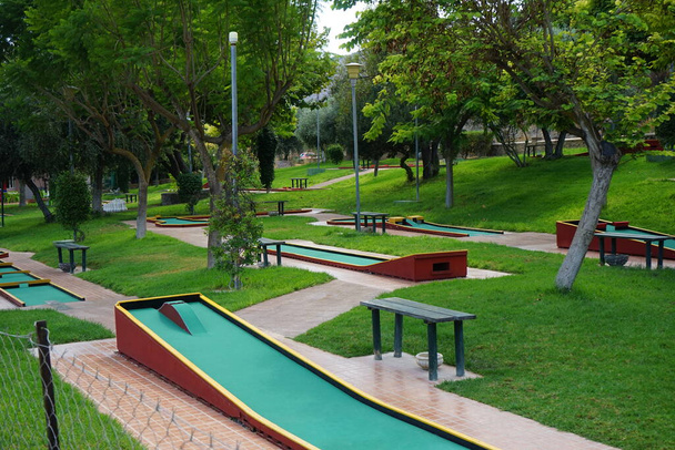 Miniature golf in Lardos. Miniature golf, minigolf, putt-putt, crazy golf, and by several other names is an offshoot of the sport of golf focusing solely on the putting aspect of its parent game. Lardos, Rhodes Island, South Aegean region, Greece - Photo, Image