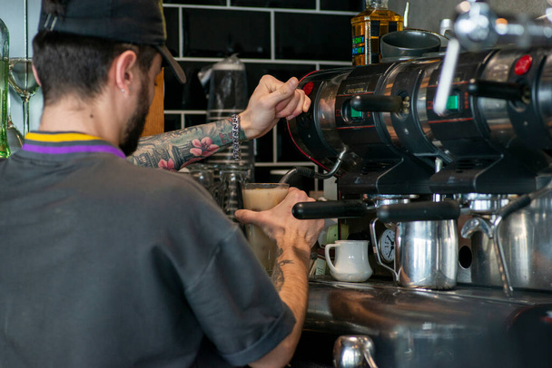 barista making a cup of coffee in a cafe - Photo, Image