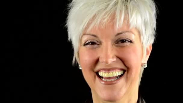 Business middle aged woman laughs - black background - studio - detail (closeup) - Footage, Video