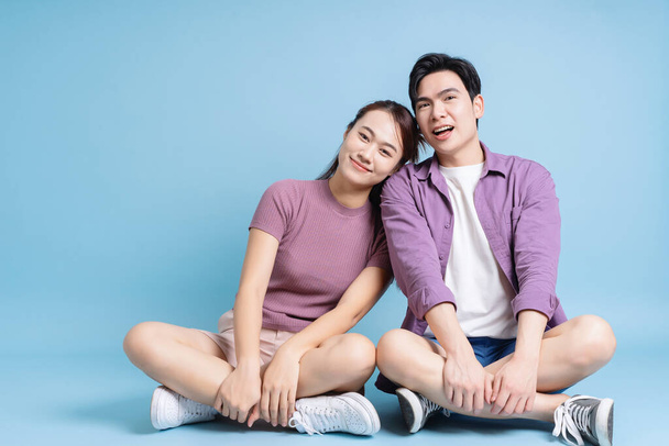 Young Asian couple on blue background - Photo, Image
