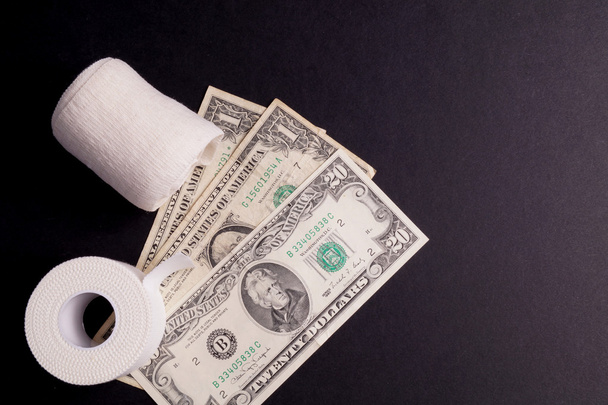 Therapeutic self adhesive tape and Money - 写真・画像
