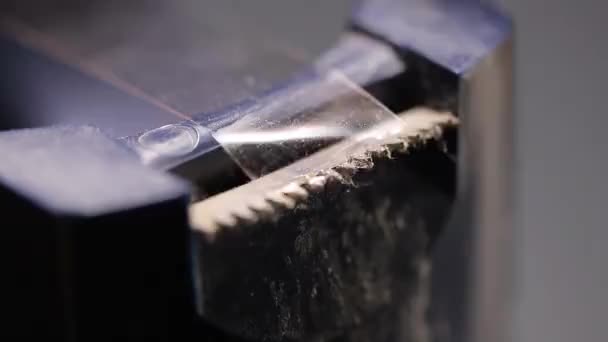 Pulling scotch tape in tape dispenser in macro shot - Footage, Video