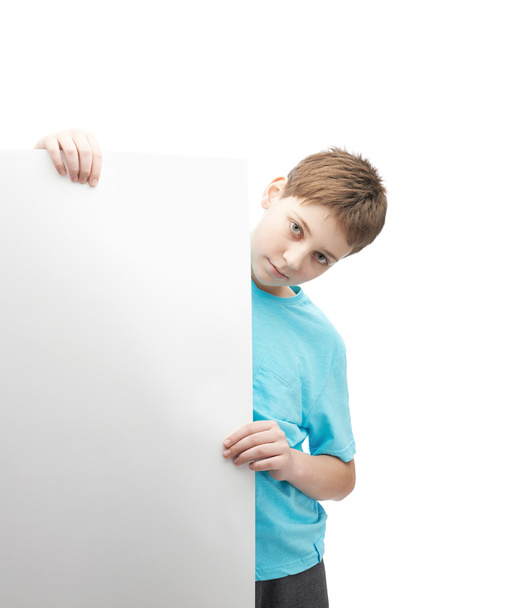Serious young boy with a sheet of paper - Fotó, kép