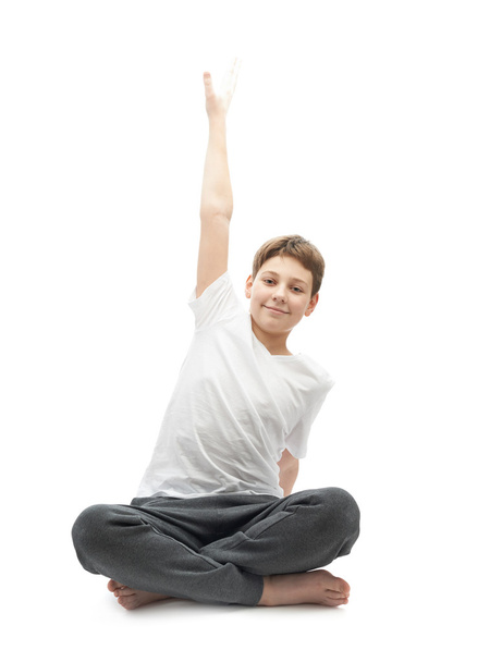 Young boy stretching or doing yoga - Zdjęcie, obraz