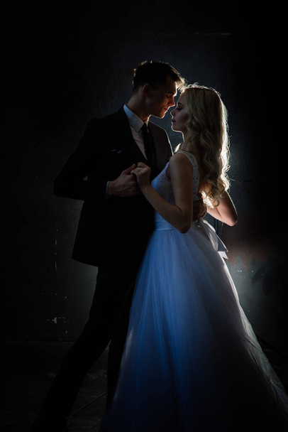 Art fashion studio photo of wedding couple silhouette groom and bride on colors background. - Fotó, kép