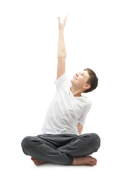 Young boy stretching or doing yoga - 写真・画像