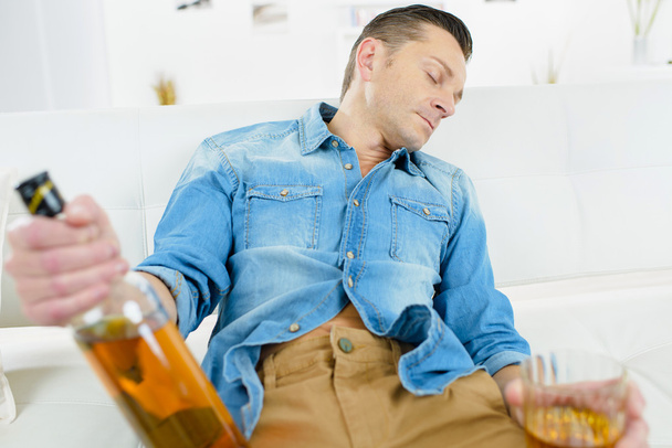 Drunk man on a sofa - Photo, Image