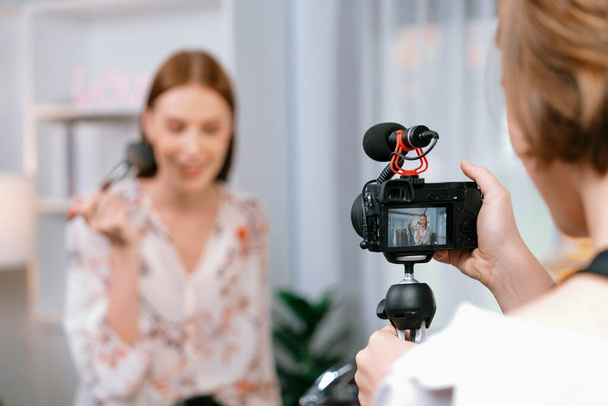 Woman influencer shoot live streaming vlog video review makeup utmost social media or blog. Happy young girl with cosmetics studio lighting for marketing recording session broadcasting online. - Photo, Image