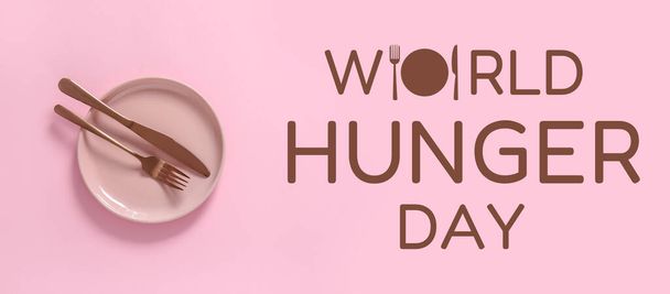Maailman nälkäpäivän lippu lautasella, veitsellä ja haarukalla - Valokuva, kuva