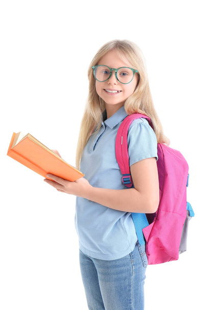 Cute schoolgirl with pink backpack and book on white background - Photo, Image