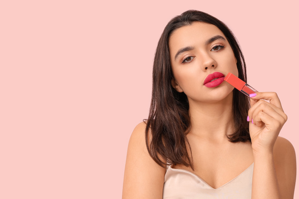 Beautiful young woman with stylish lipstick on pink background - Foto, afbeelding