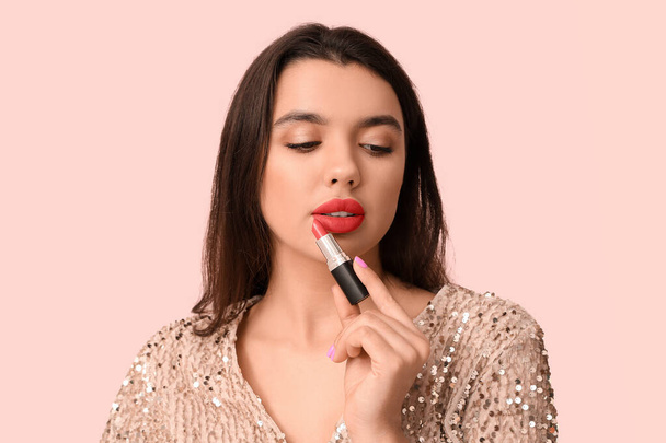 Beautiful young woman with stylish lipstick on pink background - Photo, Image