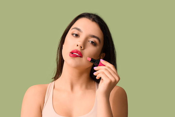 Beautiful young woman with stylish lipstick on green background - Photo, Image