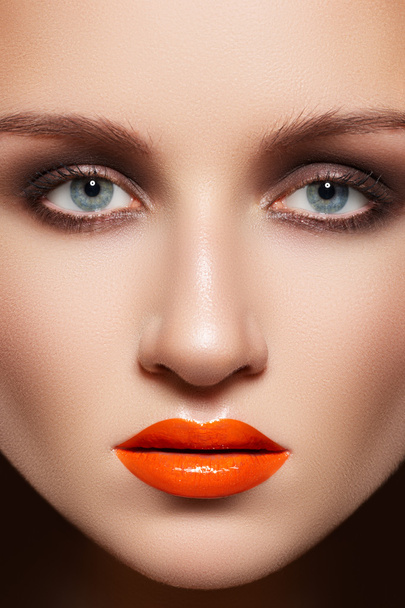 Glamourous woman face with fashion make-up. Sexy gloss make-up on lips - Photo, image
