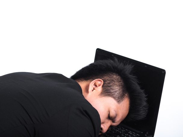 young business man sleeping on his laptop isolated on white. - Foto, imagen
