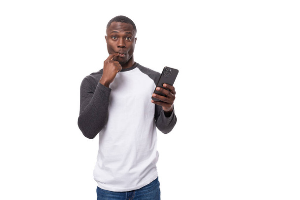 young charming charismatic businessman american man holding smartphone in surprise. - Photo, Image