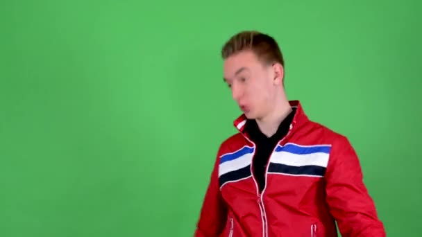 Young handsome man is crazy: swing with messenger bag  - green screen - studio - Footage, Video