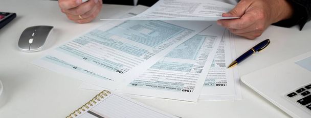 Jungunternehmer Buchhaltung und Ausfüllen individueller uns Steuerformular 1040. Finanzielle Schwierigkeiten, Steuersystem - Foto, Bild
