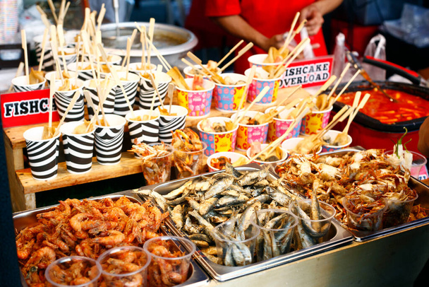 Photo of assorted fried seafood sold at a street food cart. - Photo, Image