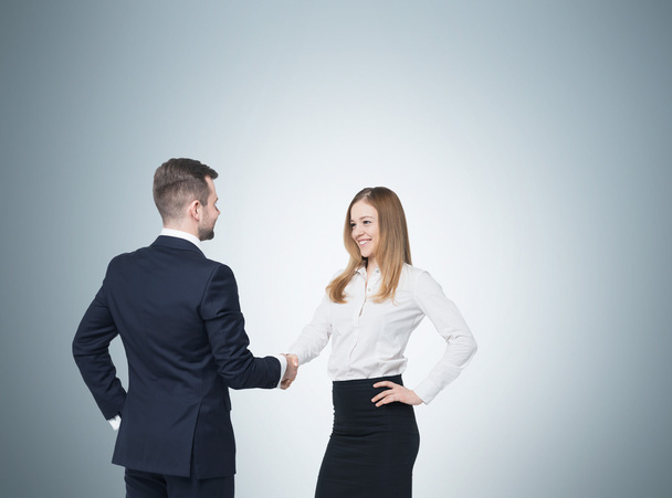 Young couple at the business meeting. Handshake as a concept of successful deal. - Foto, Imagem