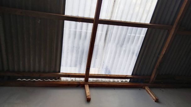 Jasné odpolední sluneční světlo proniká střechou domu azbestovým materiálem a UV plastem s vlnovou strukturou - Fotografie, Obrázek