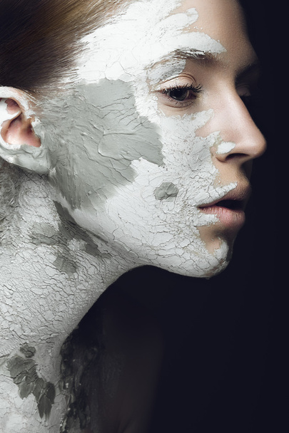 Beautiful girl with mud on his face. Cosmetic mask. Beauty face. - Φωτογραφία, εικόνα