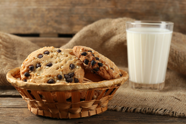 Tasty cookies and glass of milk on rustic wooden background - Foto, Imagem