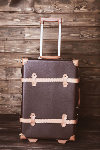 Suitcase on wooden background - Valokuva, kuva
