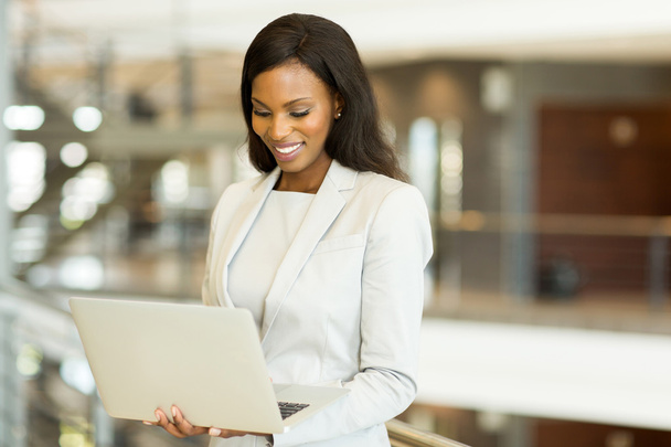 black businesswoman working on laptop in office - Фото, изображение