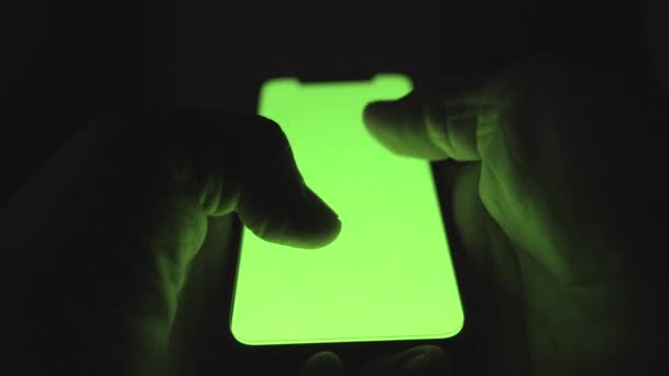 Utilice la pantalla verde para el primer plano del espacio de copia. Chroma clave maqueta en el teléfono inteligente en la mano en la noche. Enfoque selectivo. Imágenes de alta calidad 4k - Imágenes, Vídeo