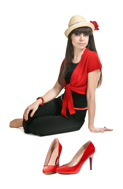 Beautiful girl on the background of a pair of red women's shoes. - Fotografie, Obrázek