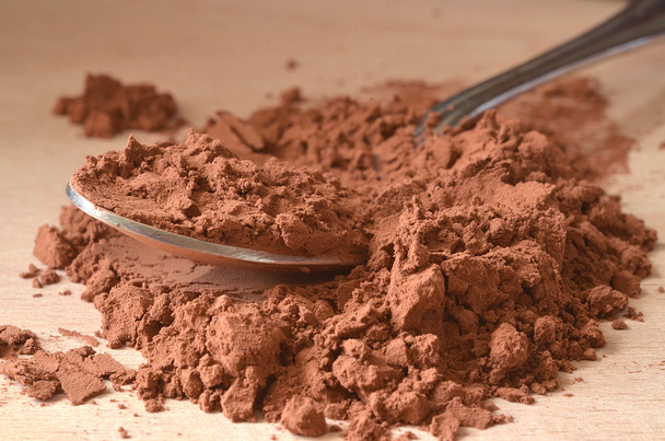Spoon in brown powder - 写真・画像