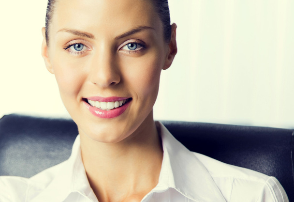Smiling young businesswoman at office - Photo, Image
