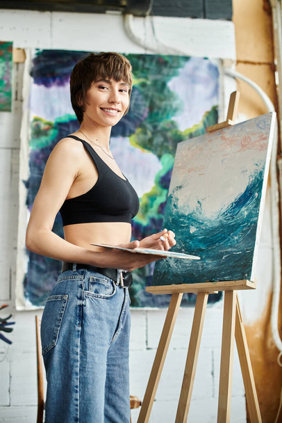 Woman creates masterpiece at easel. - Photo, Image