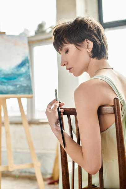 A woman seated with brush. - Photo, Image