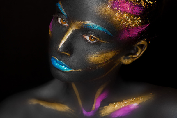 Close-up fashion portrait of a dark-skinned girl with color make-up - Photo, Image