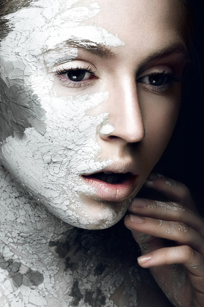 Beautiful girl with mud on his face. Cosmetic mask. Beauty face. - Photo, image