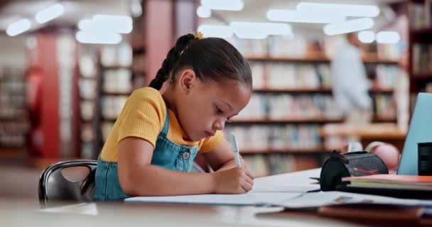 Dítě, psaní a domácí úkoly v knihovně pro vzdělání znalosti nebo školní abecedy, rozvoj nebo učení. Dívka, dítě a pero pro kreativní projekt jako student mládeže s kresbou, notebookem nebo papírem. - Záběry, video
