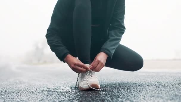 Fitness, shoes and hands tie laces in road for race, competition or marathon training with running. Sports, health and closeup of woman athlete preparing for outdoor cardio exercise or workout - Footage, Video
