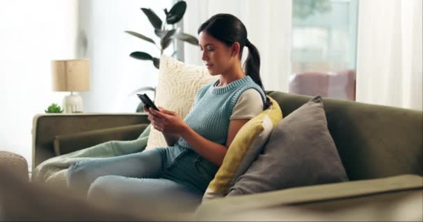 Home, woman and smartphone with typing, relax and online reading for social media and message a contact. Apartment, person on a sofa or girl with a cellphone and mobile user with digital app or email. - Felvétel, videó