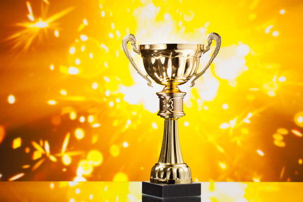 золотой кубок трофей на фоне блестящих искр
 - Фото, изображение
